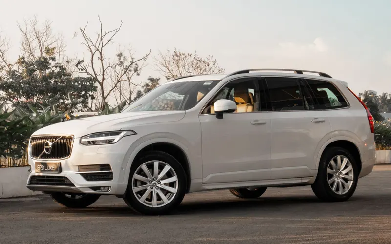White SUV parked along a tree-lined road