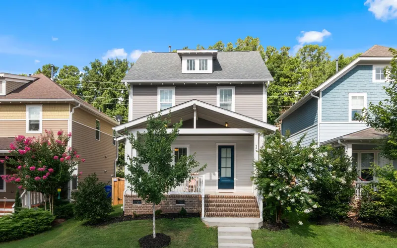 Craftsman-style home with a front porch and blooming crepe myrtles