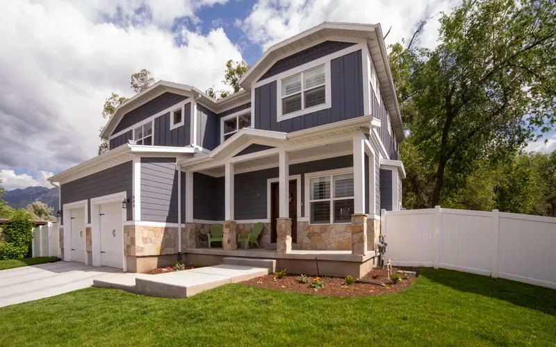 Two-story rental house with a white fence and fresh landscaping